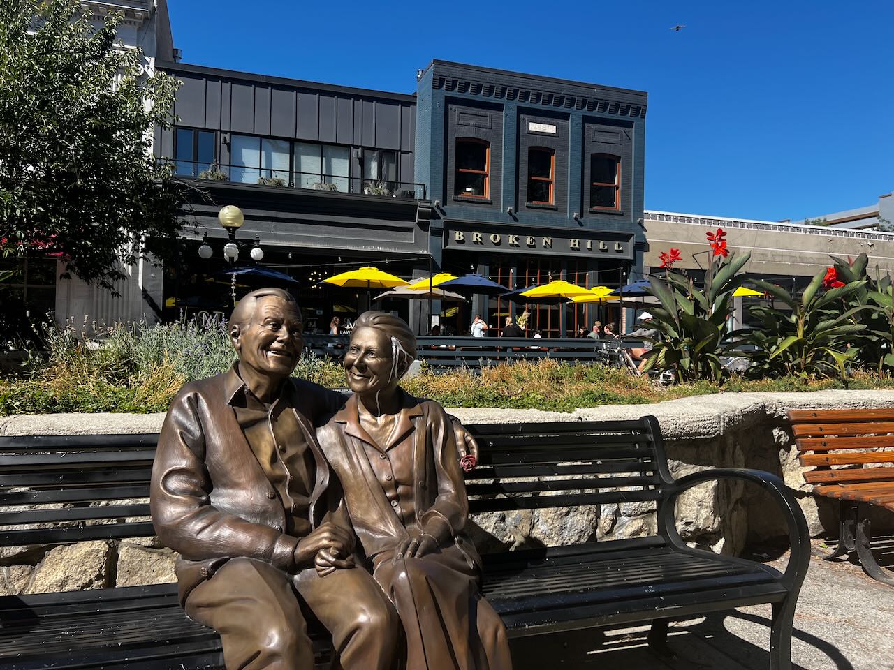 Statue of a couple sitting on a bench in downtown Nelson