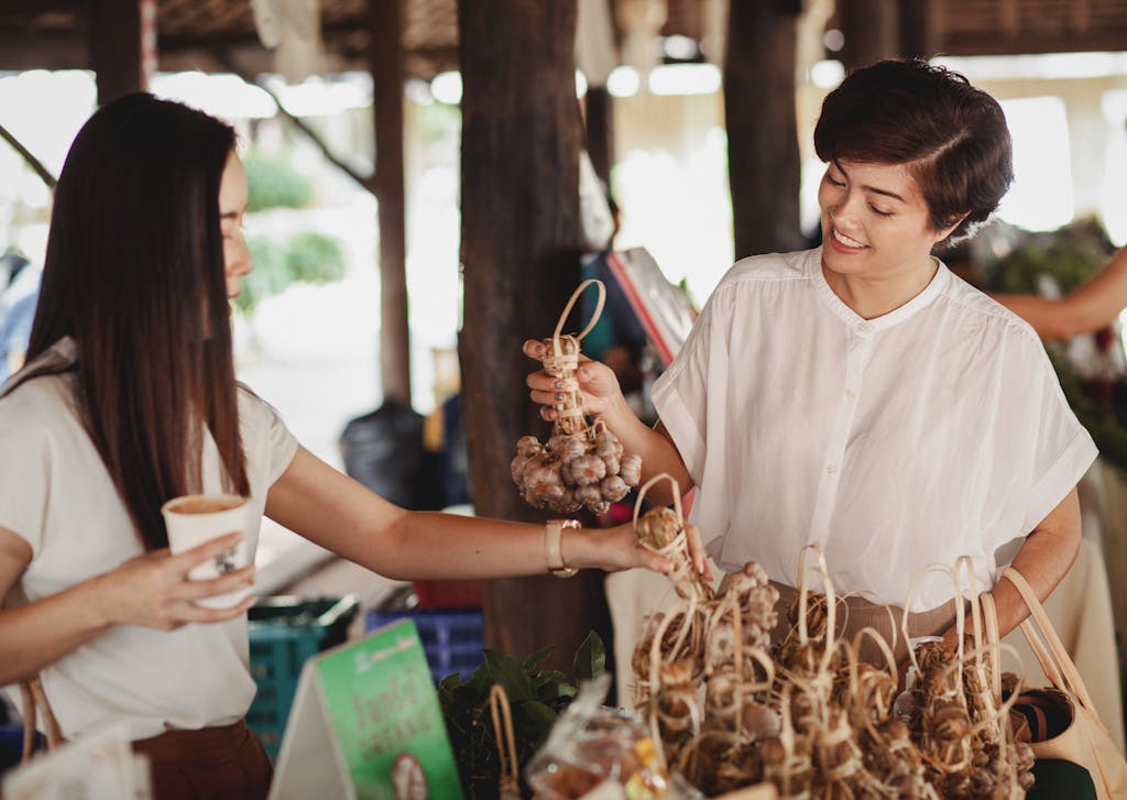 Ethnic women choosing ginseng at street market