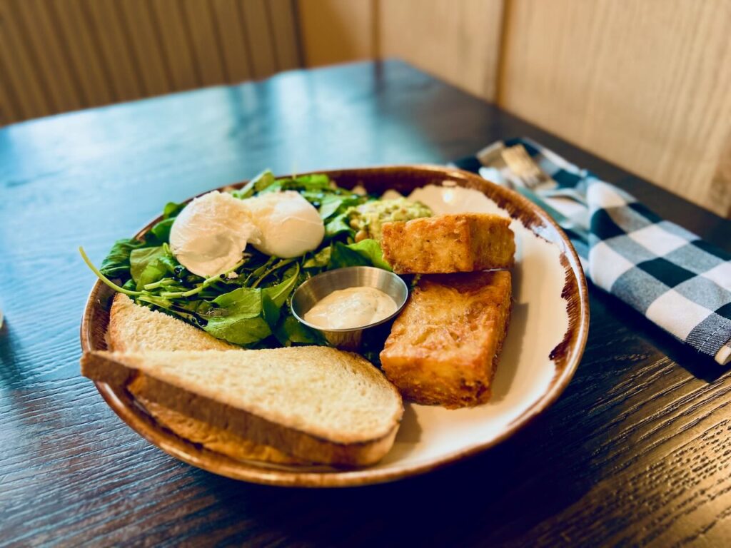 Avocado on Rost at Marzano restaurant in Nelsoni: poached eggs on shredded roti with avocado salsa and sourdough
