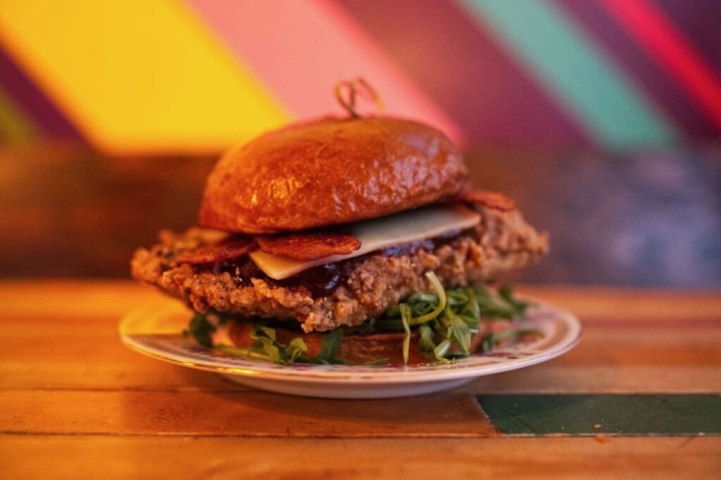 crunchy chicken burger with banana peppers and cola reduction at The Royal