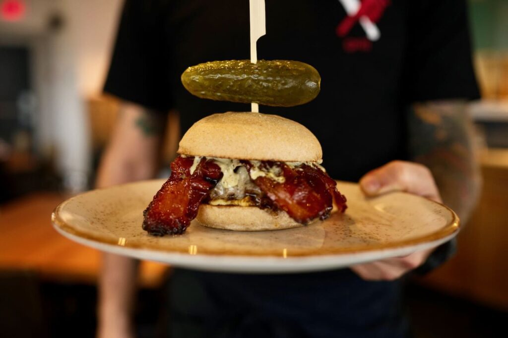 Ainsworth Hot Springs burger with brown sugar candied bacon, elk and boar, and shishito pepper aioli 